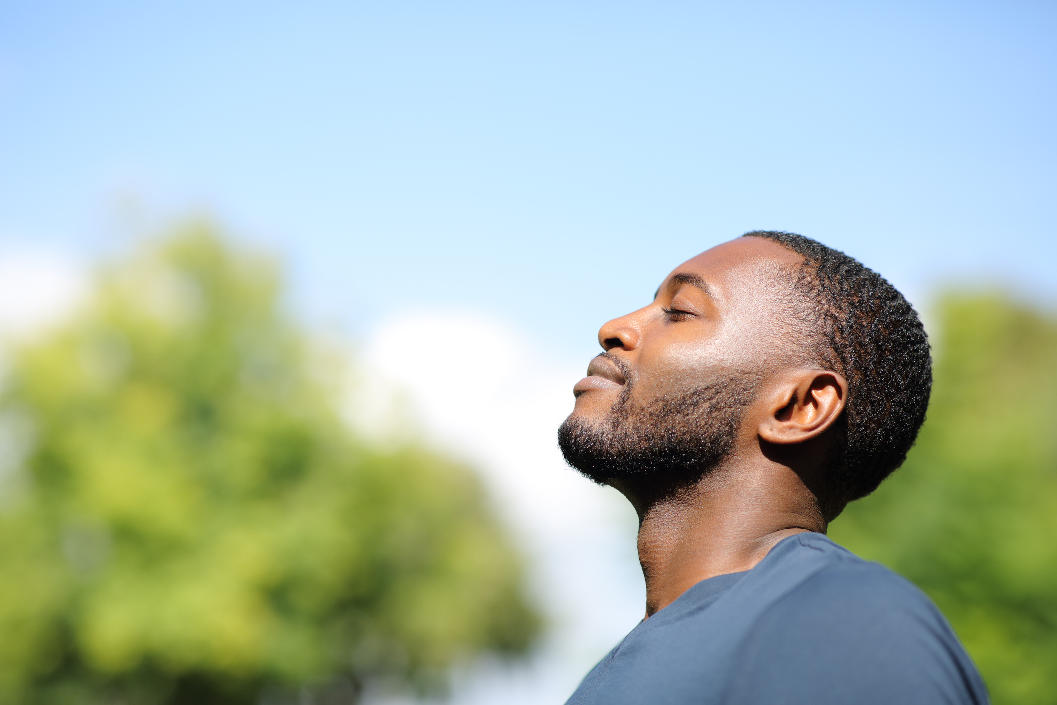 Profile of a man breathing fresh air in nature
