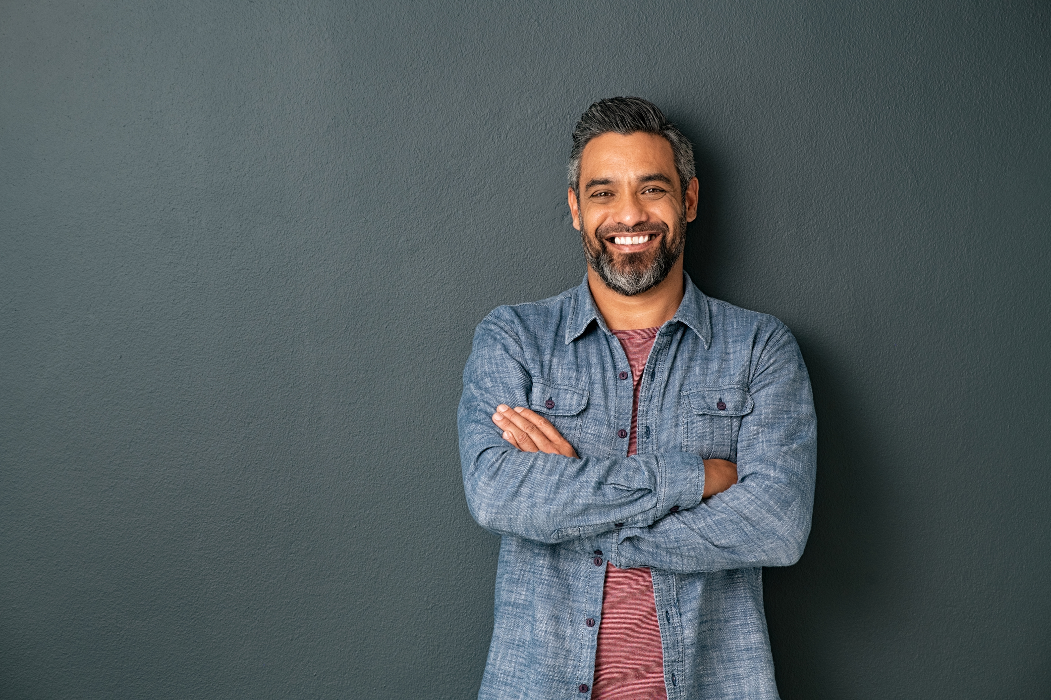 Smiling mature man on grey background
